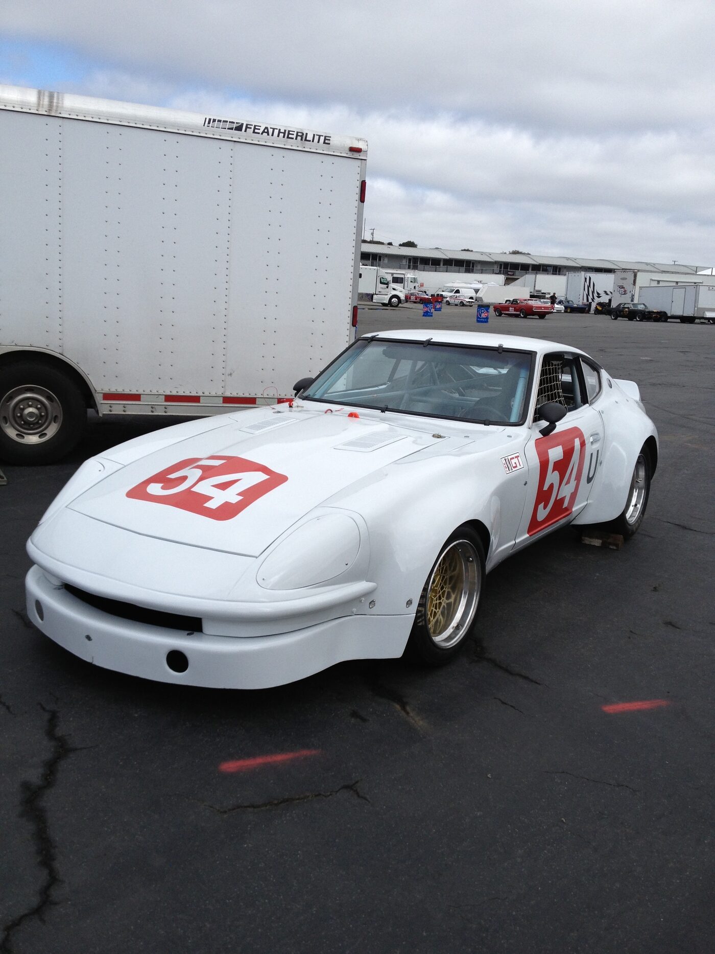 Vintage race car number 54 in the paddock