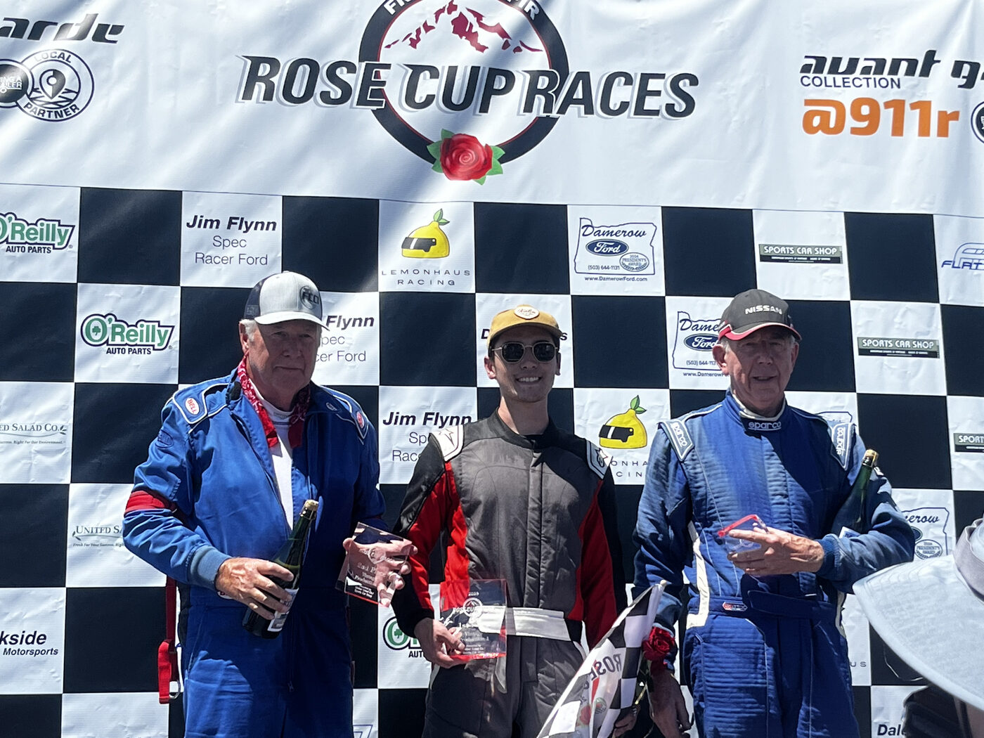 Larry Oka Racing driver holding a 1st place trophy at Laguna Seca